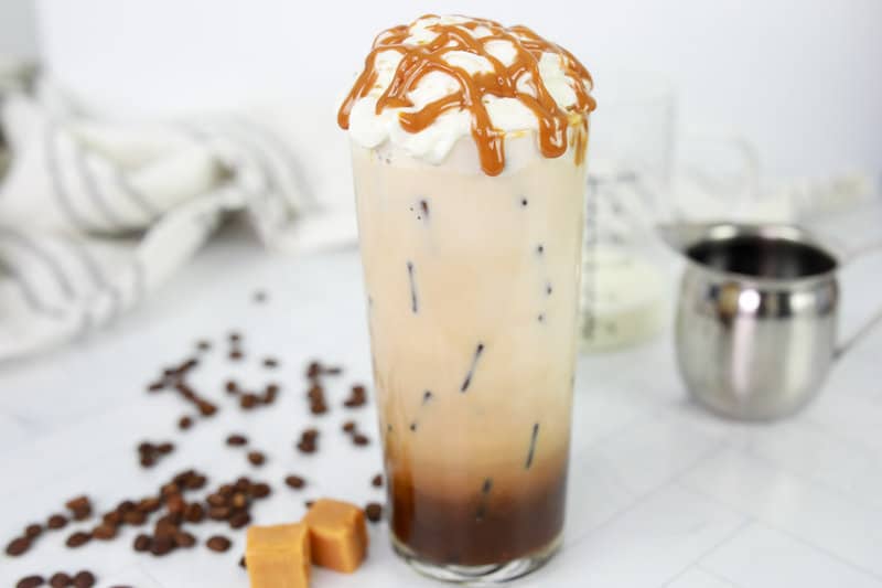 copycat Starbucks iced caramel macchiato with whipped cream and caramel drizzle.