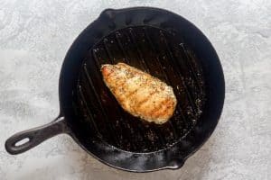 cooked chicken breast in a cast iron skillet.