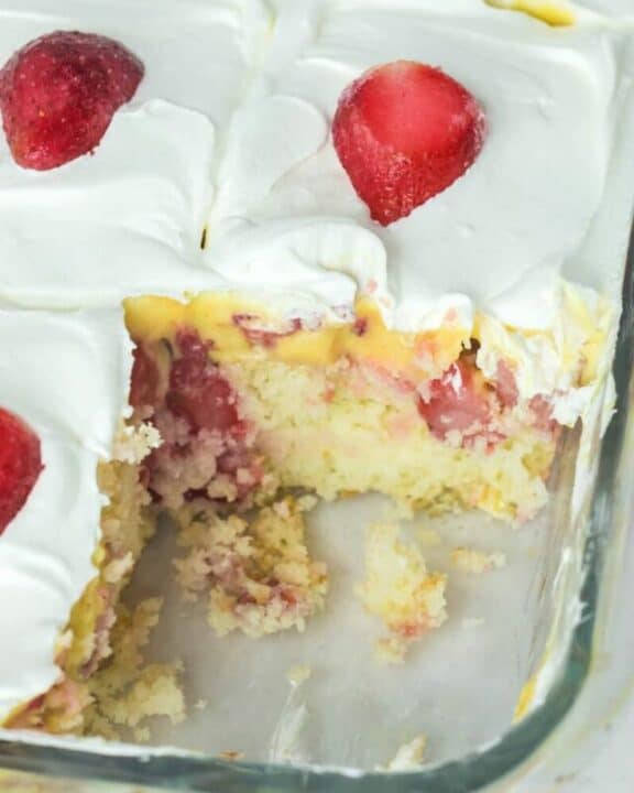 strawberry poke cake in a glass baking dish.
