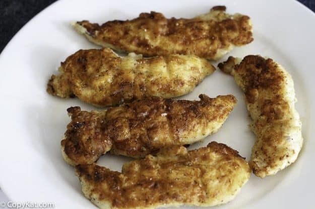 pan fried chicken tenders on a plate.