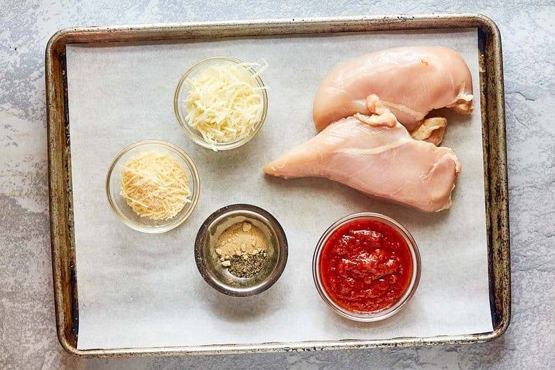 baked chicken parmesan ingredients on a tray.