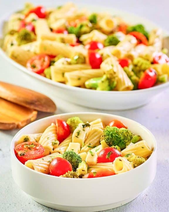 broccoli pasta salad in a bowl and on a large platter.