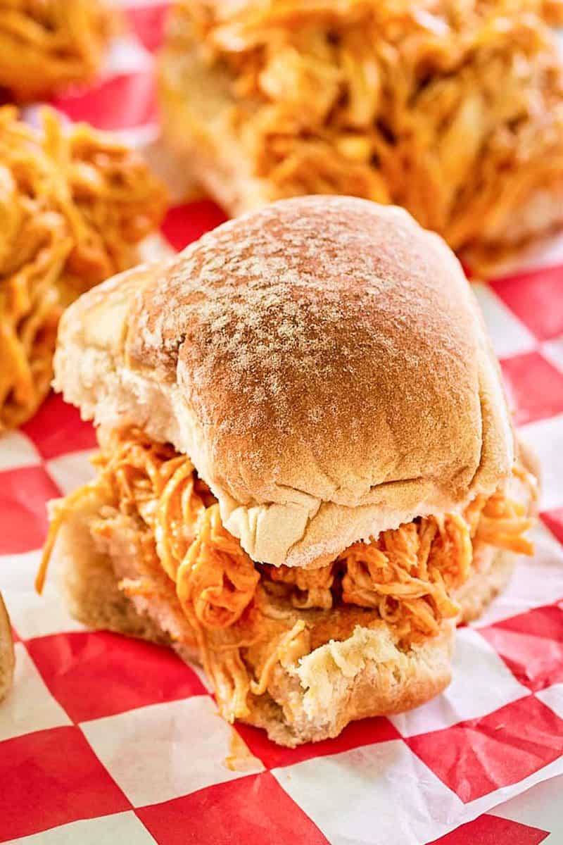 buffalo chicken slider on red checkered parchment paper.