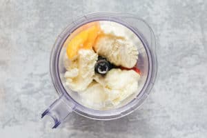 milk, ice cream, and peaches in a blender.