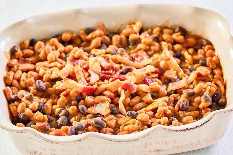 copycat cracker barrel bacon baked beans in a rectangular serving dish.