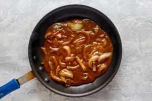 copycat Cracker Barrel onion gravy for hamburger steak in a skillet.