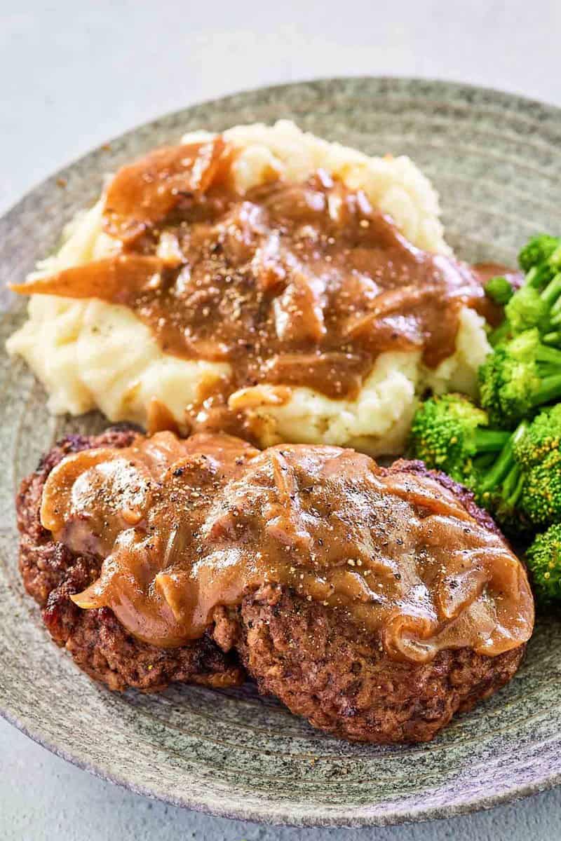 copycat Cracker Barrel hamburger steak and onion gravy on a plate.