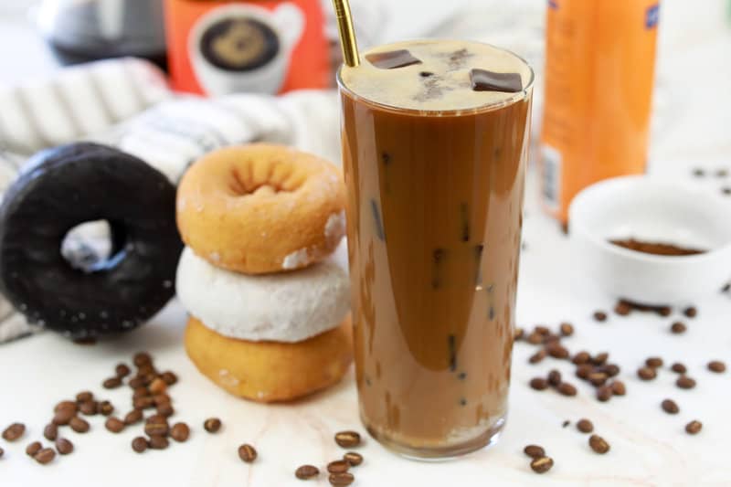 copycat Dunkin Donuts caramel iced coffee and four donuts.