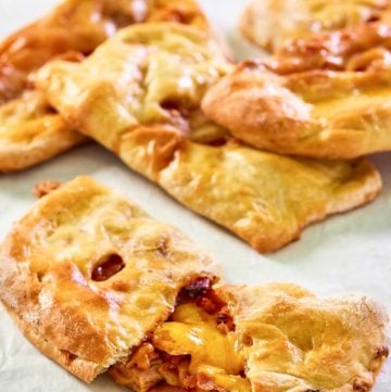 homemade ham and cheese pockets on parchment paper.