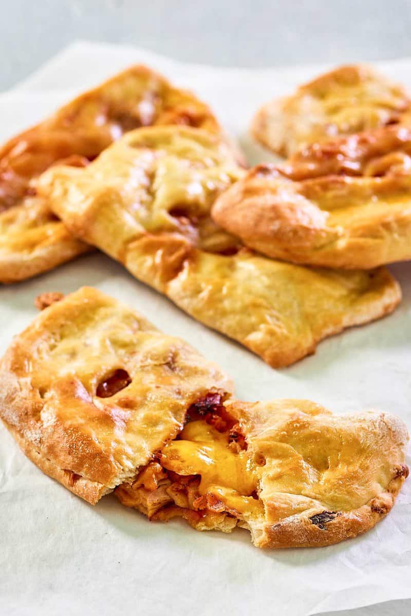 homemade ham and cheese pockets on parchment paper.