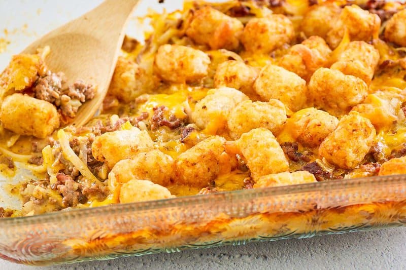 cheesy hamburger hashbrown casserole in a glass baking dish.