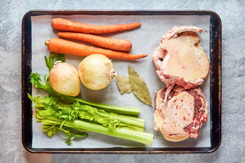 Instant Pot beef bone broth ingredients on a tray.