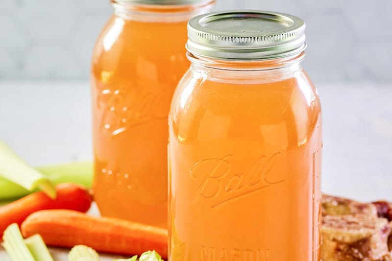 homemade Instant Pot beef bone broth in two mason jars.