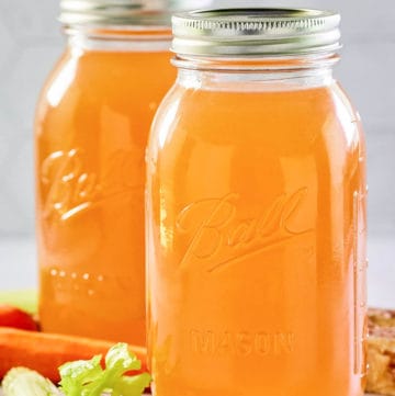 Instant Pot beef bone broth in two mason jars.