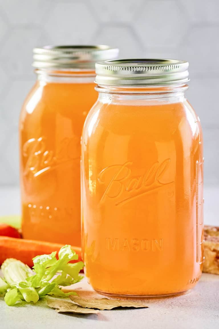 Instant Pot beef bone broth in two mason jars.