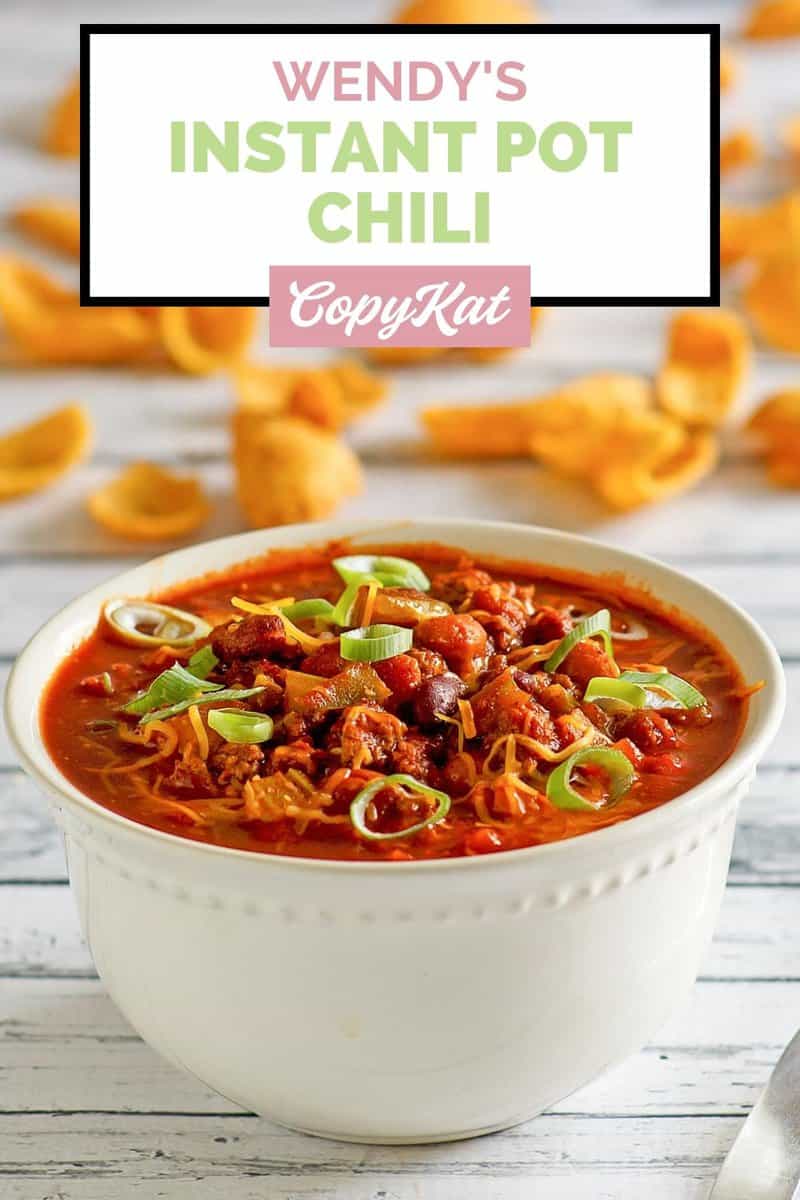 bowl of copycat Instant Pot Wendy's chili and corn chips behind it.
