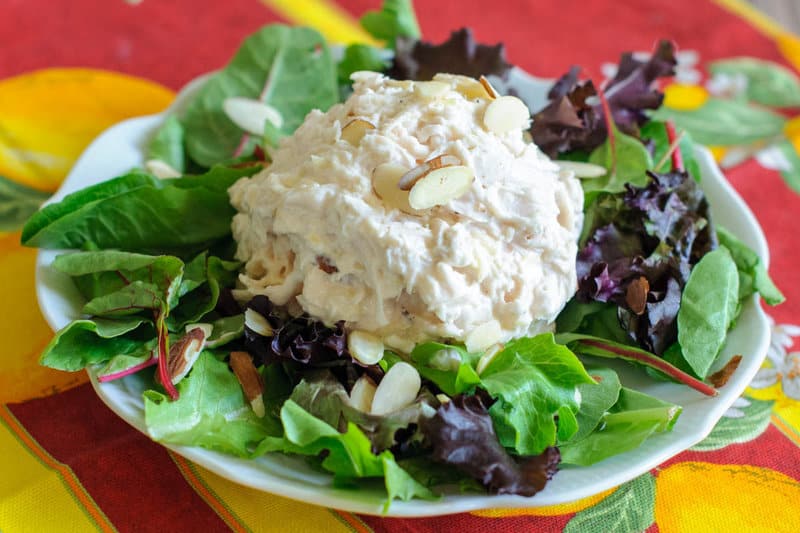 copycat Jason's Deli chicken salad on top of mixed salad greens on a plate.