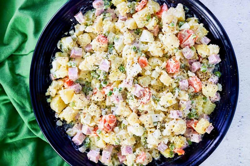 olivier salad in a bowl and a green napkin.