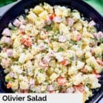overhead view of olivier salad in a black bowl.