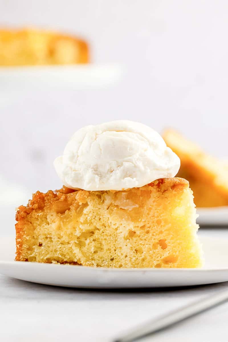 slice of pineapple upside down cake with ice cream on top.