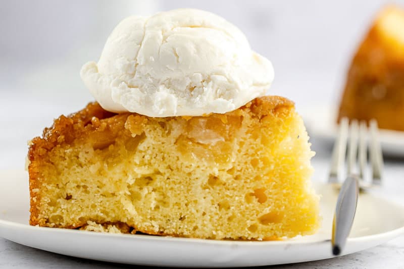 pineapple upside down cake slice topped with ice cream.