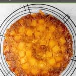 homemade pineapple upside down cake on a round wire rack.