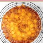 pineapple upside down cake on a round wire rack.