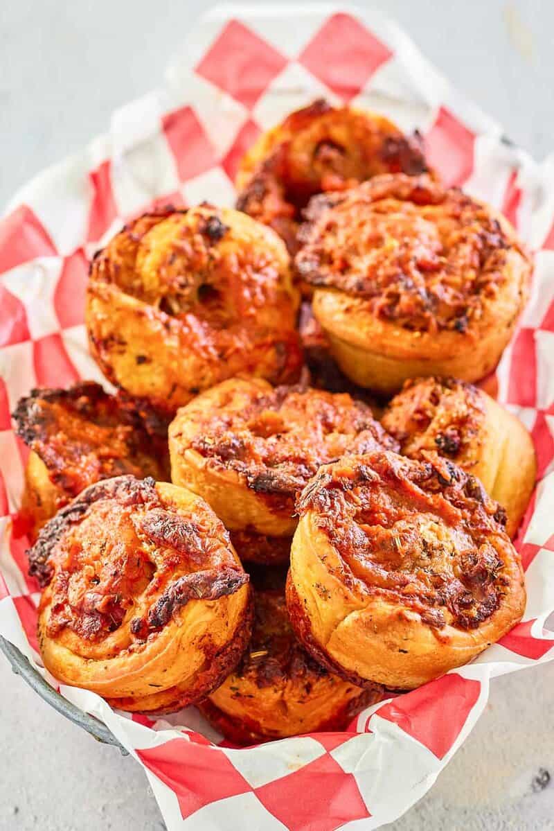 a bread basket filled with homemade pizza rolls.