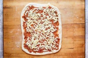 pizza dough topped with meat sauce and cheese.
