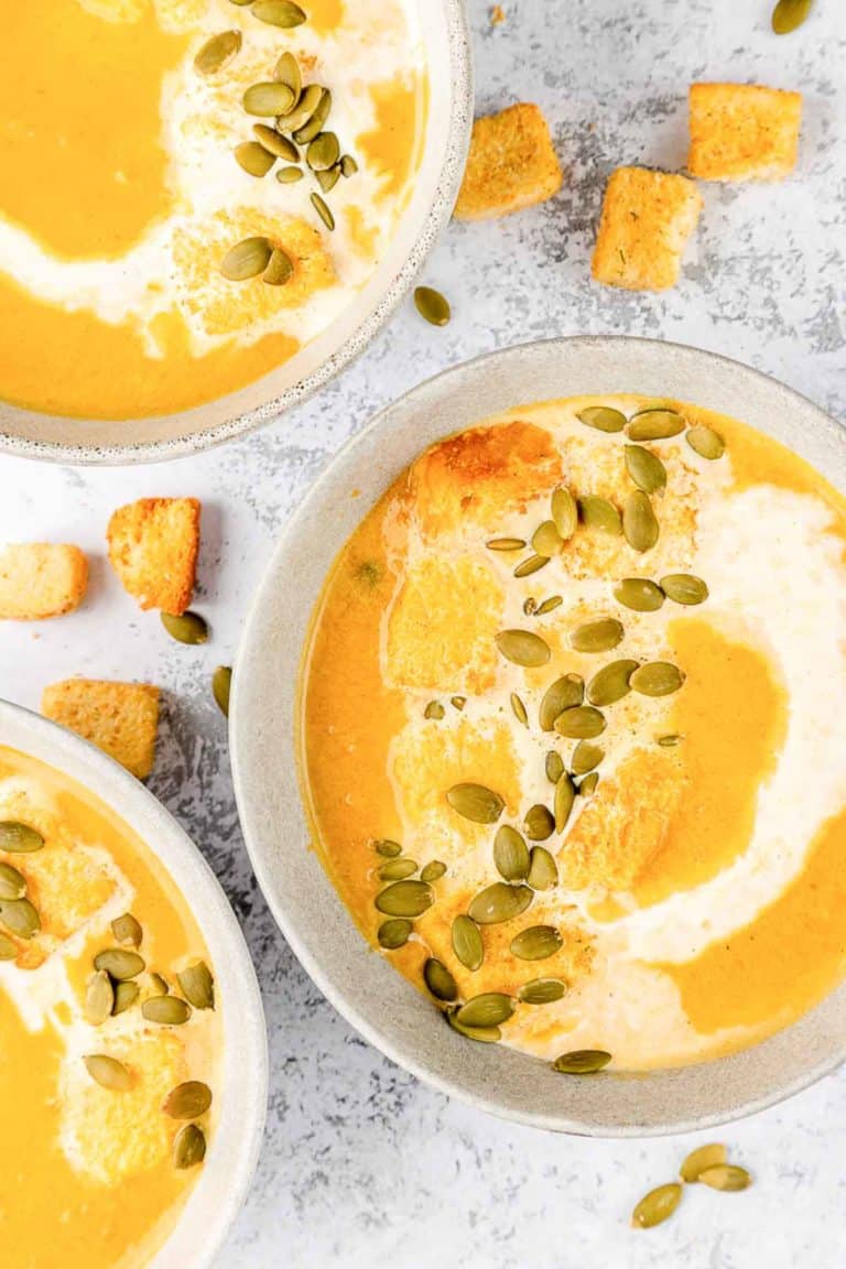 overhead view of pumpkin bisque in three bowls.
