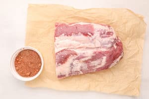 raw pork belly and dry rub mix.