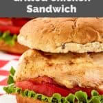 closeup of a homemade Chick Fil A grilled chicken sandwich with lettuce and tomato.