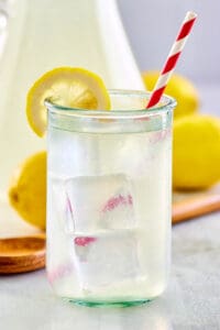 copycat Chick Fil A lemonade in a glass and pitcher.