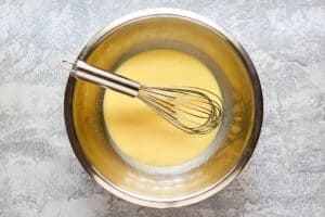 IHIP French toast batter and a whisk in a bowl.