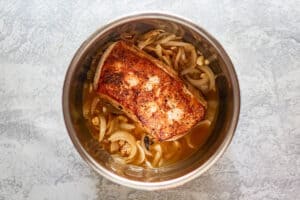 browned pork loin, cooked onions, and apple cider in an Instant Pot.