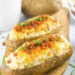 two loaded twice baked potatoes and one russet potato.