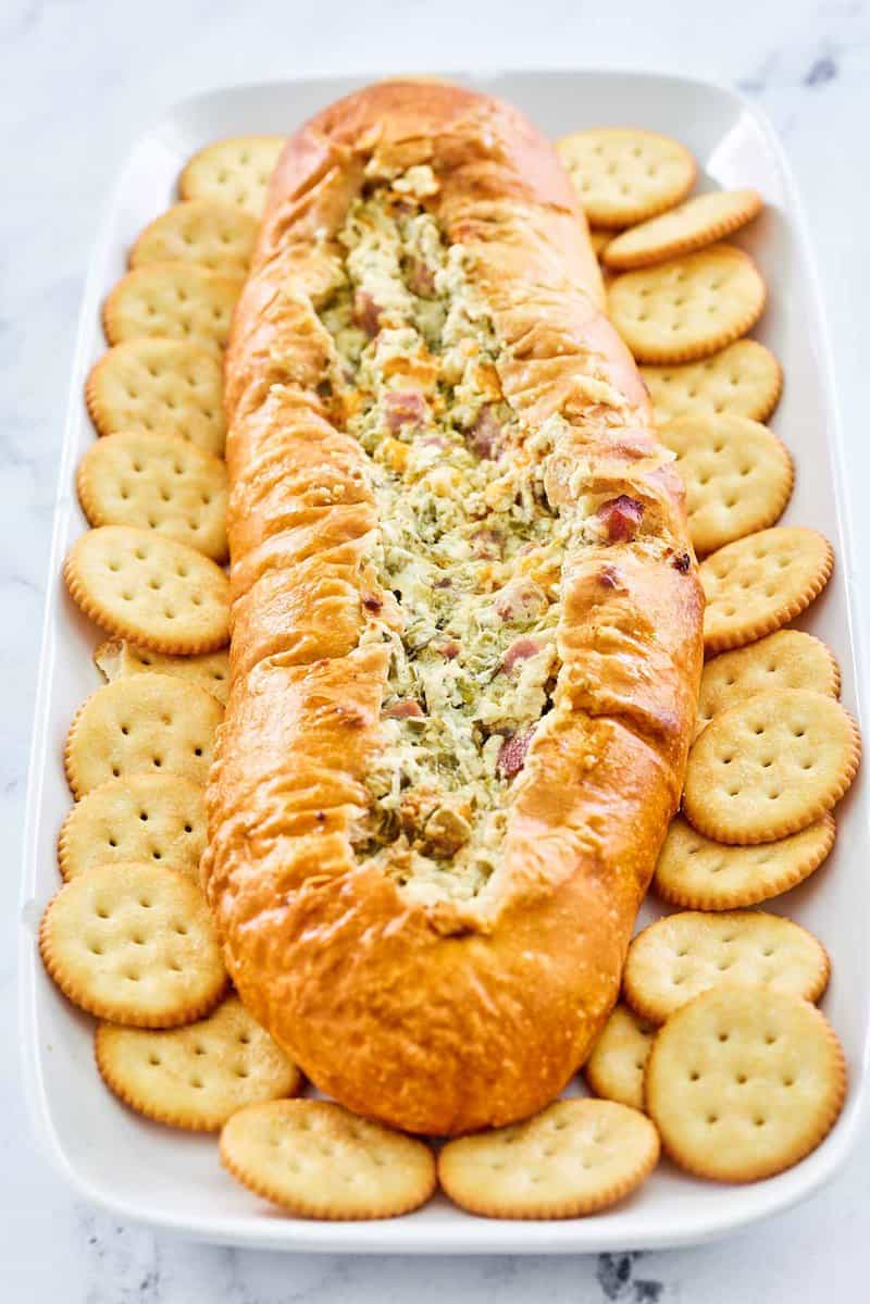 Mississippi Sin Dip and butter crackers on a long white platter.