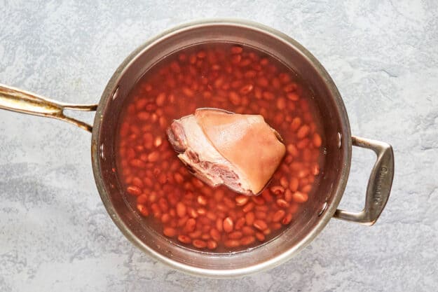 red beans and ham hock in a pan.