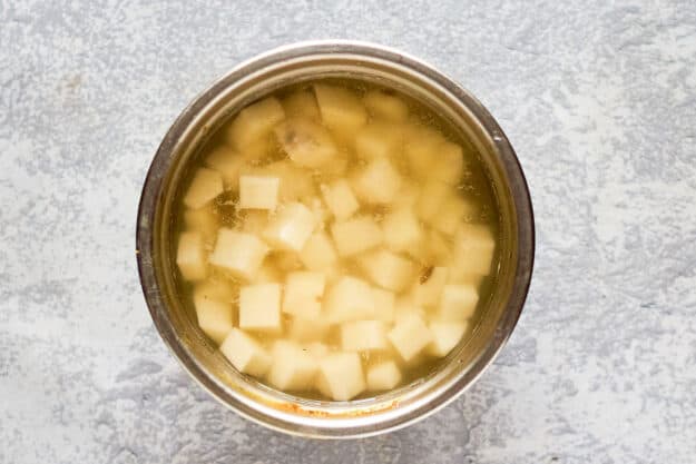 potato cubes soaking in water.