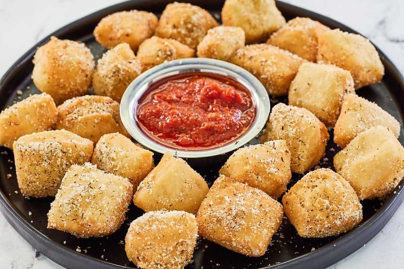 copycat Rosati's dough nuggets and a small bowl of marinara on a platter.