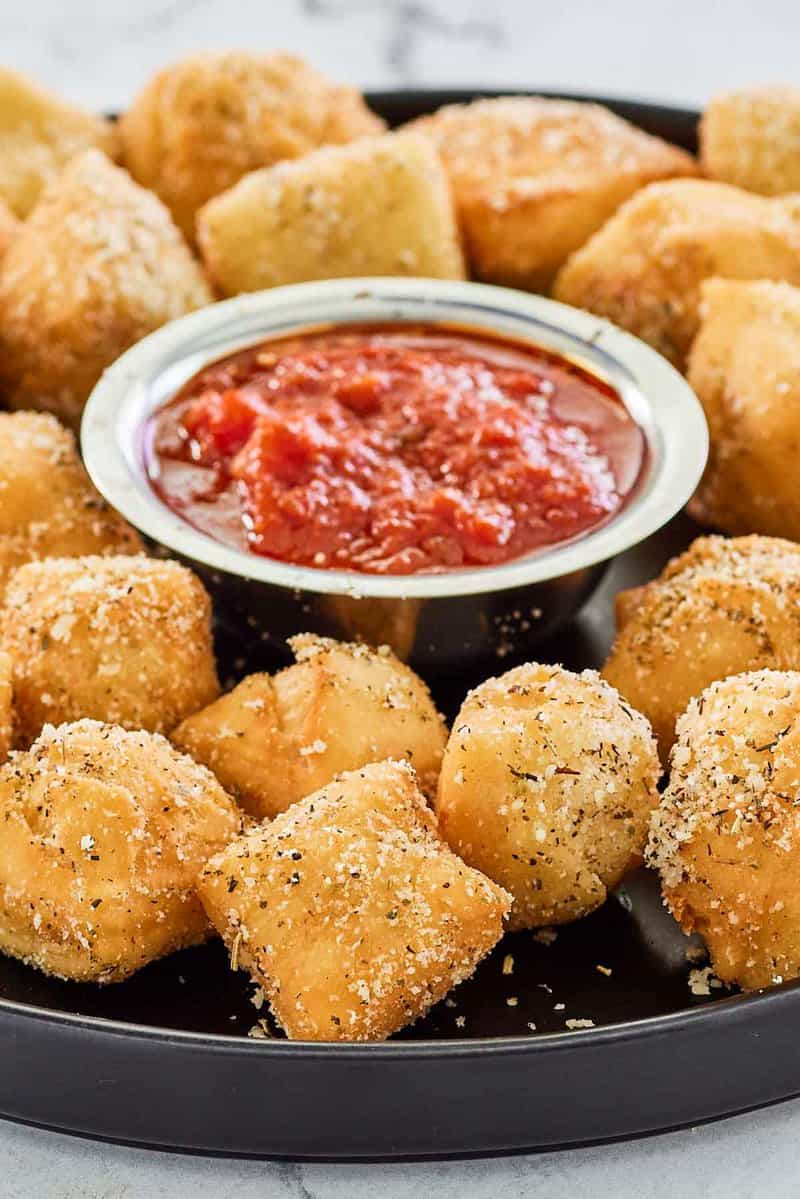 copycat Rosati's dough nuggets with a small bowl of marinara sauce.