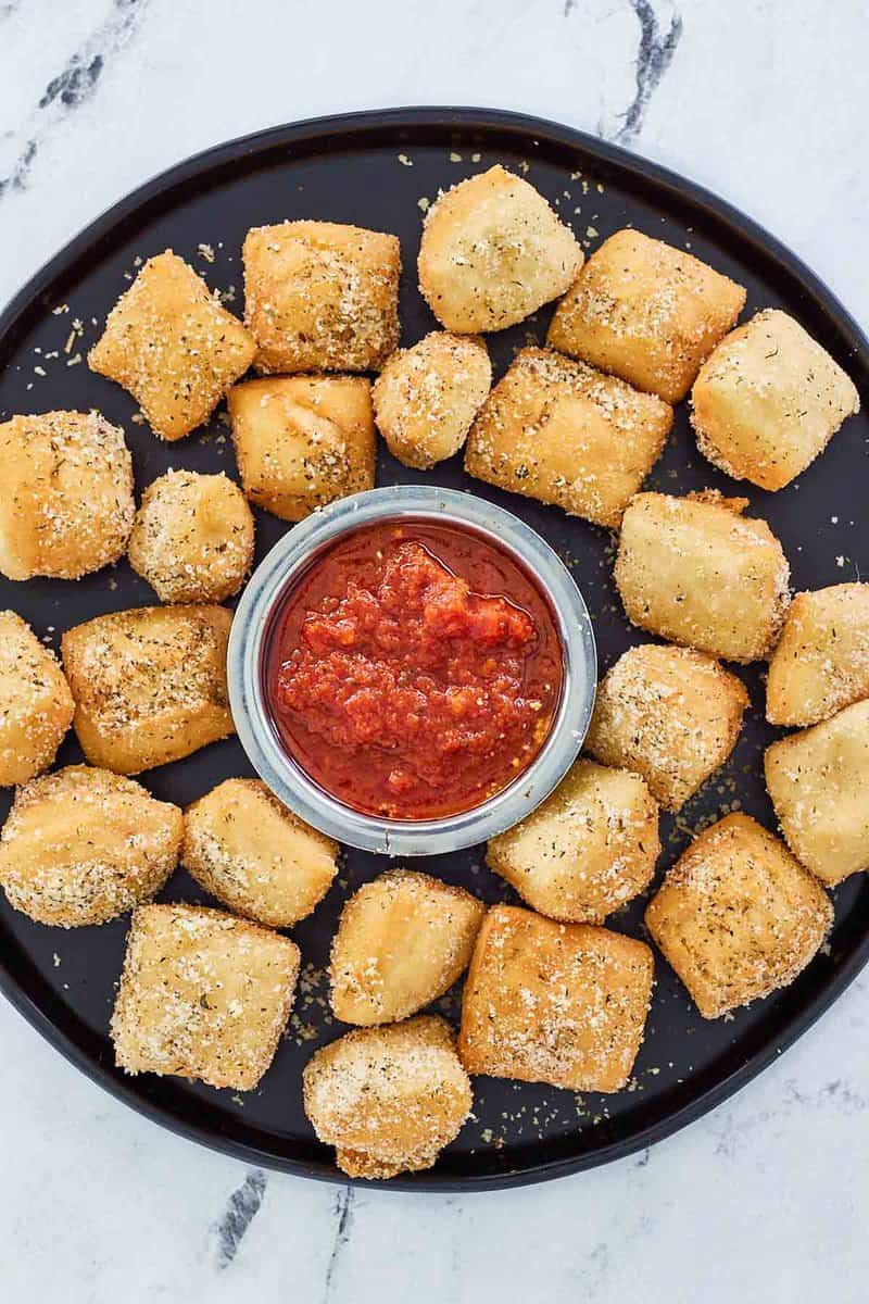 overhead view of copycat Rosati's dough nuggets with marinara sauce.