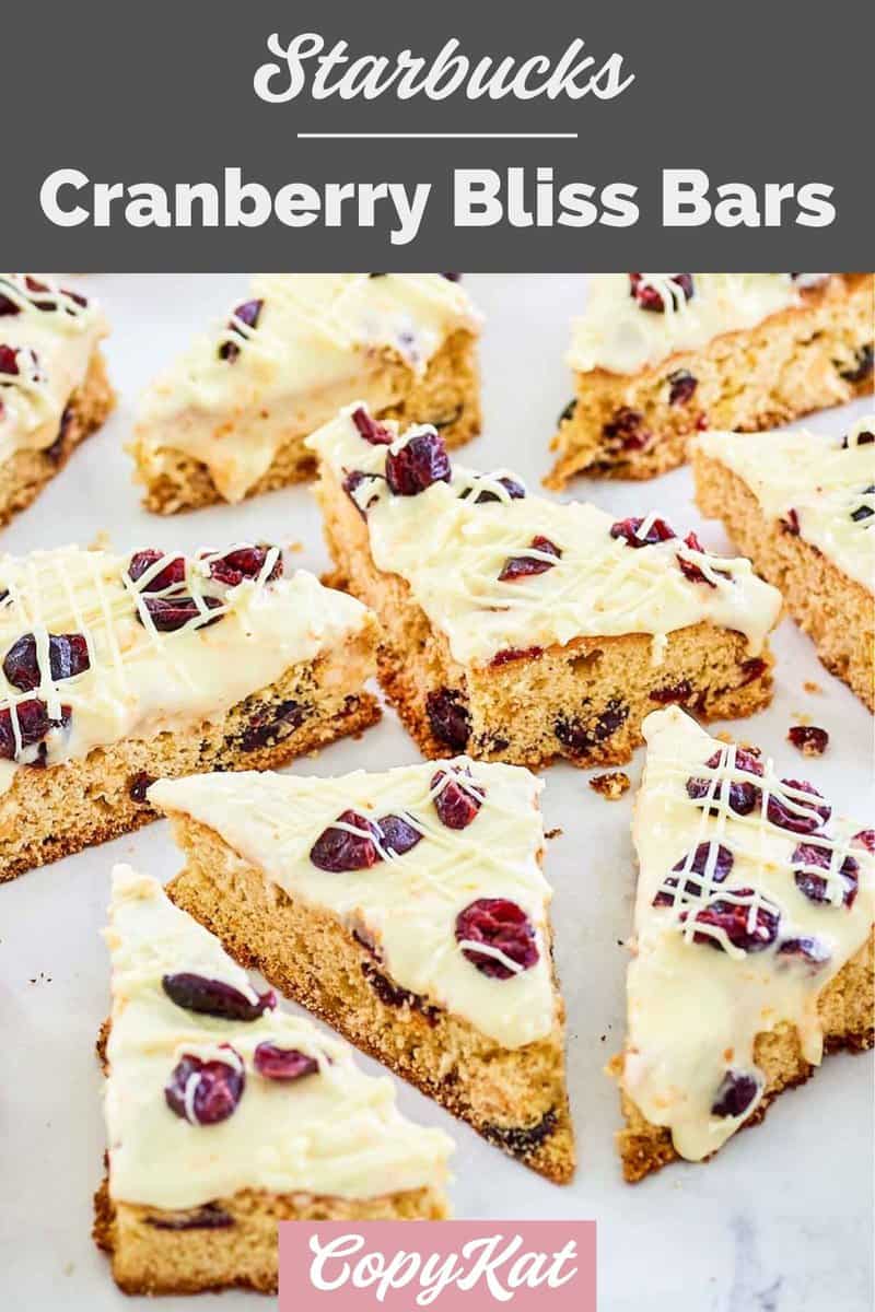 homemade Starbucks cranberry bliss bars scattered on parchment paper.
