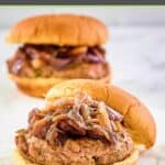 two turkey burgers with caramelized onions on wheat buns.