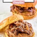 two turkey burgers topped with caramelized onions.