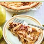 slice of apple pie cheesecake and a fork on a plate.