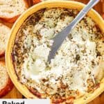 baked goat cheese and a cheese spreader in a bowl.