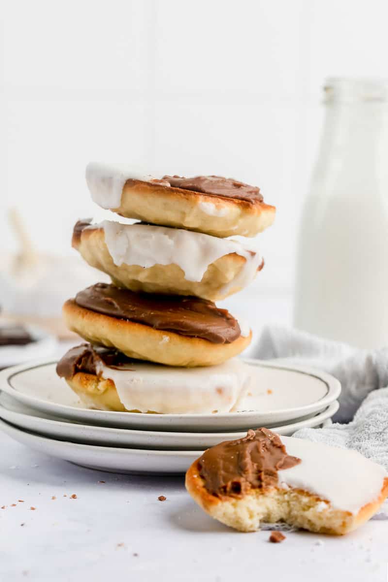 four black and white cookies stacked and one beside them.