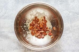 pecans and whipped egg white in a bowl.