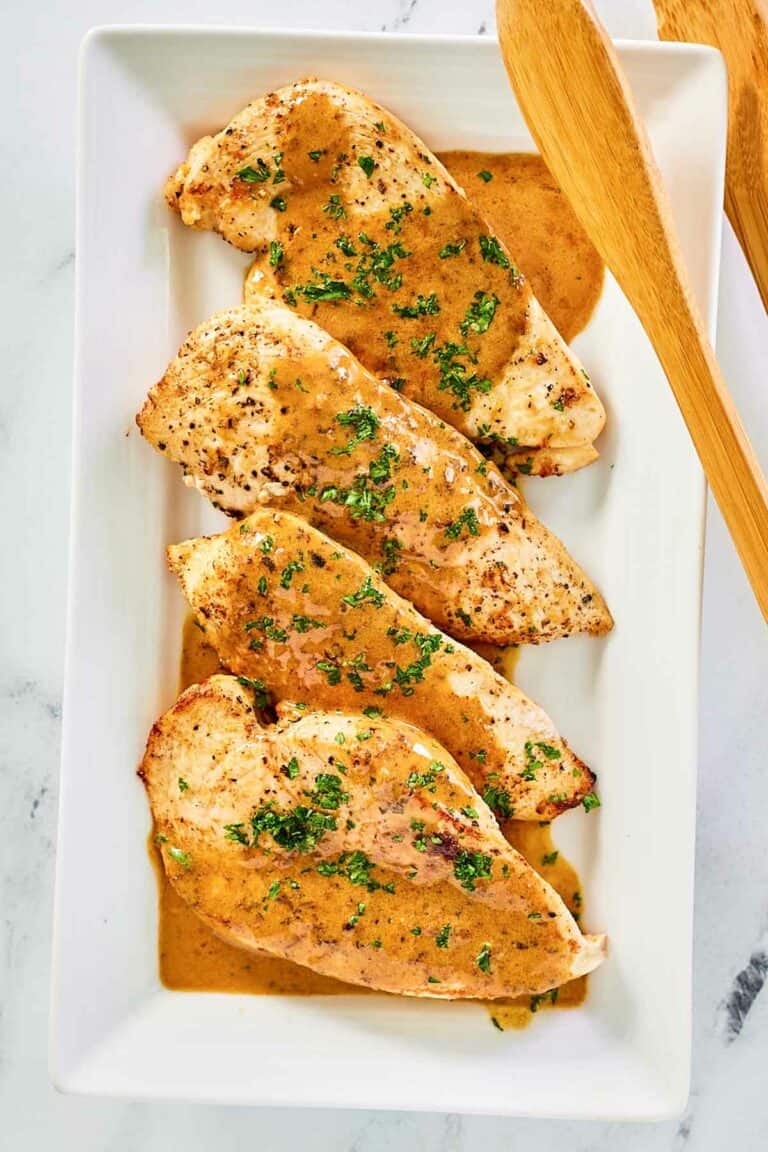 overhead view of chicken dijon and sauce on a platter.